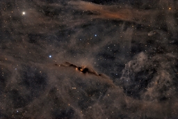 The Red Glow of the Cosmic Bat Nebula