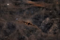 The Red Glow of the Cosmic Bat Nebula